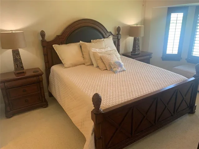 a bedroom with a bed and a night stand