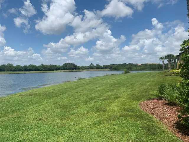a view of a lake with houses in the back
