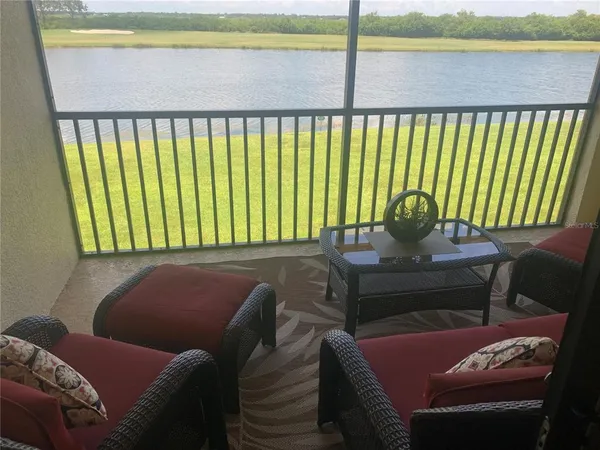 a view of a chair and table in the balcony