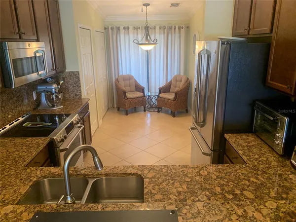 a kitchen with a sink appliances and a window