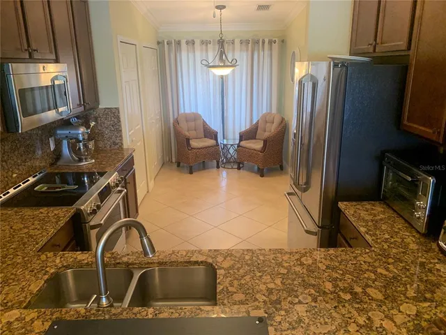a kitchen with a sink appliances and a window