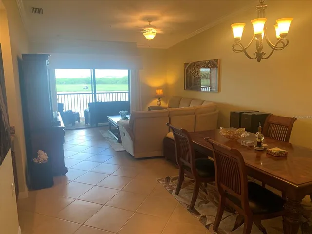 a view of a dining room with furniture and a chandelier