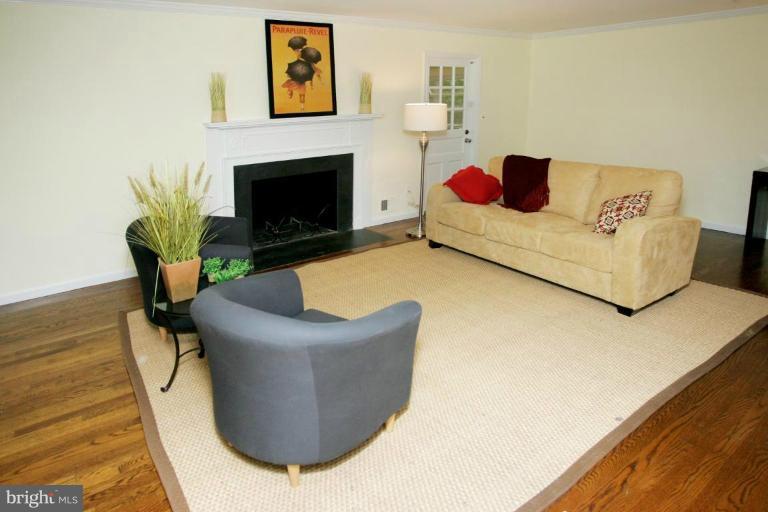 7912 Greentree Road Bethesda, MD 20817 - Photo 2 of 23 a living room with furniture and a fireplace
