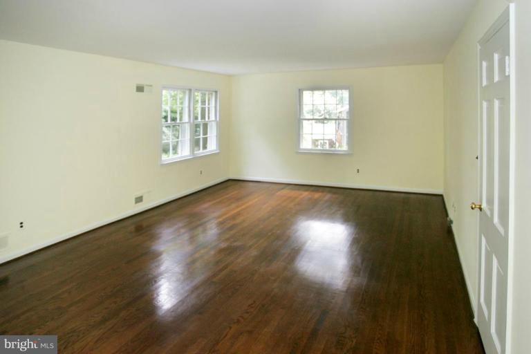 7912 Greentree Road Bethesda, MD 20817 - Photo 12 of 23 a view of an empty room with wooden floor and a window