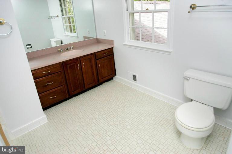 7912 Greentree Road Bethesda, MD 20817 - Photo 14 of 23 a bathroom with a sink a toilet and window