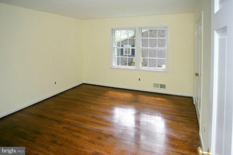 7912 Greentree Road Bethesda, MD 20817 - Photo 15 of 23 an empty room with wooden floor and windows