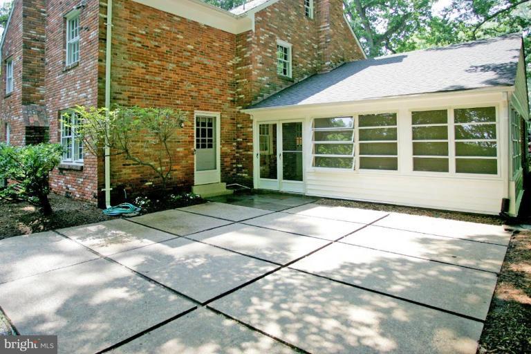 7912 Greentree Road Bethesda, MD 20817 - Photo 19 of 23 a front view of a house with a yard and potted plants