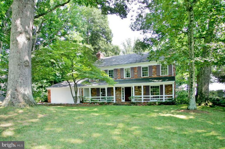 7912 Greentree Road Bethesda, MD 20817 - Photo 22 of 23 a front view of a house with a garden