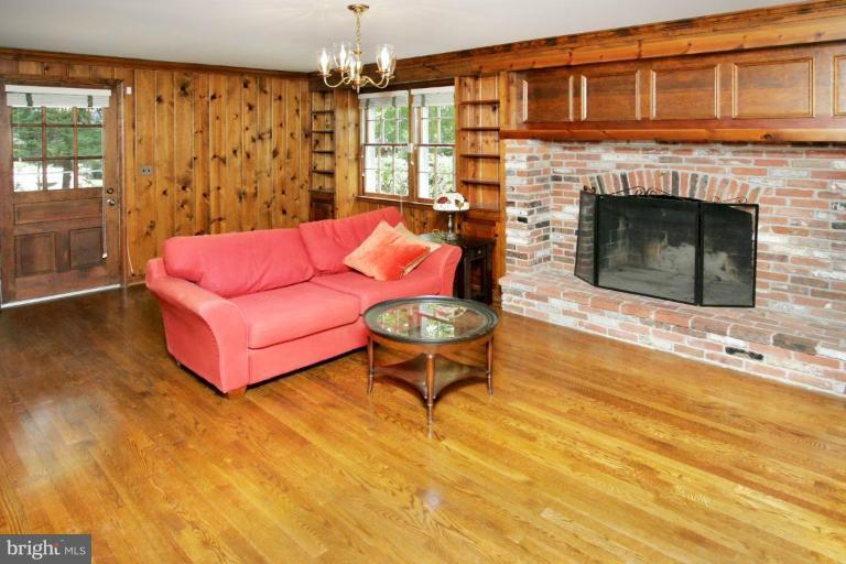 7912 Greentree Road Bethesda, MD 20817 - Photo 9 of 23 a living room with furniture and a fireplace