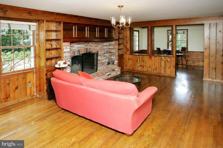 7912 Greentree Road Bethesda, MD 20817 - Photo 10 of 23 a living room with furniture and a fireplace
