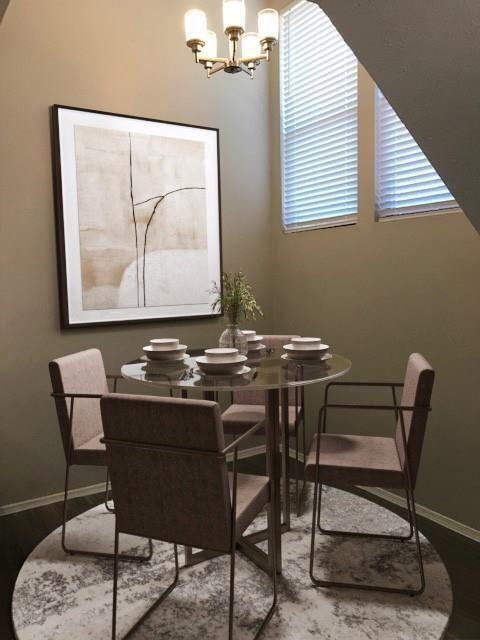 18240 Midway Road, Unit 303 Dallas, TX 75287 - Photo 9 of 21 Recessed dining area featuring a modern chandelier, two large windows with blinds, and dark wood-finish flooring