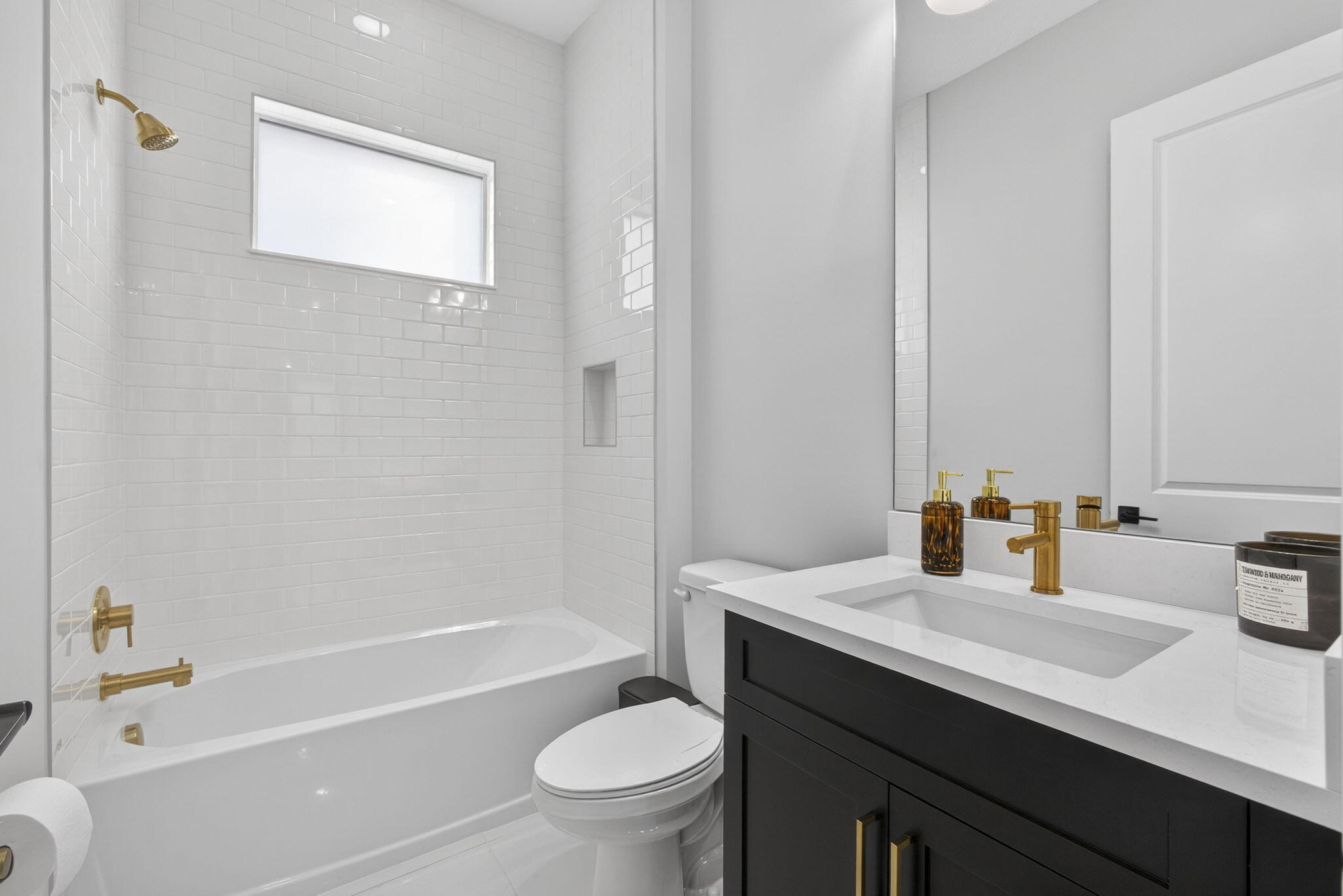 14052 Spruce Pne Drive Loxahatchee, FL 33470 - Photo 19 of 59 a bathroom with a sink a toilet a mirror a bathtub and shower