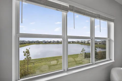 a spacious bathroom with a shower sink double mirror and shower