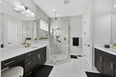 a spacious bathroom with a shower sink mirror and
