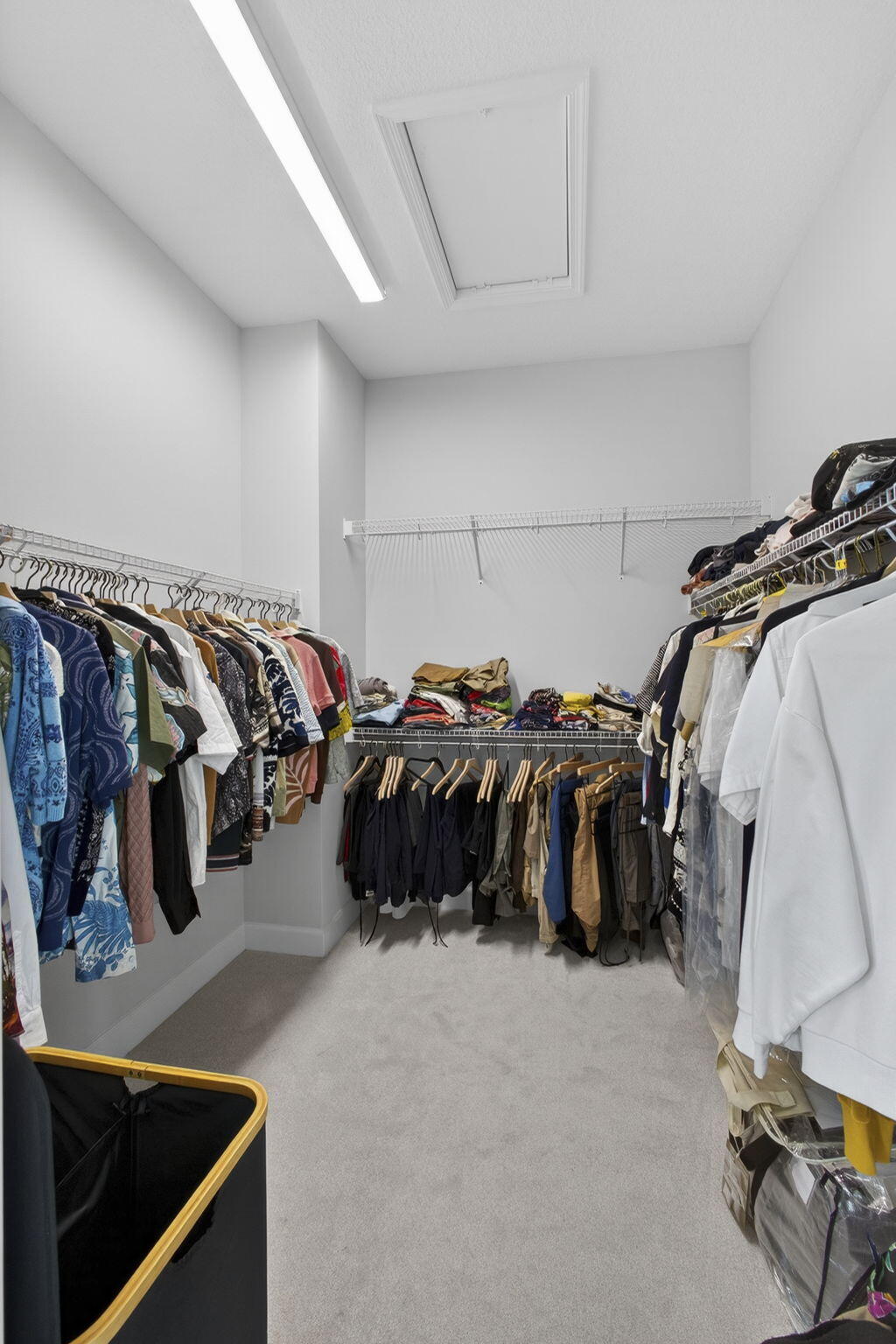14052 Spruce Pne Drive Loxahatchee, FL 33470 - Photo 25 of 59 a view of walk in closet with clothes and shoes