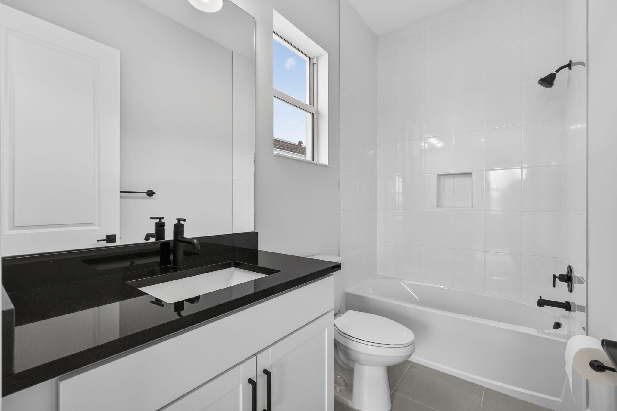 14052 Spruce Pne Drive Loxahatchee, FL 33470 - Photo 29 of 59 a bathroom with a granite countertop sink a toilet a mirror and bathtub