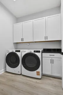 a view of a chair and table in backyard of the house