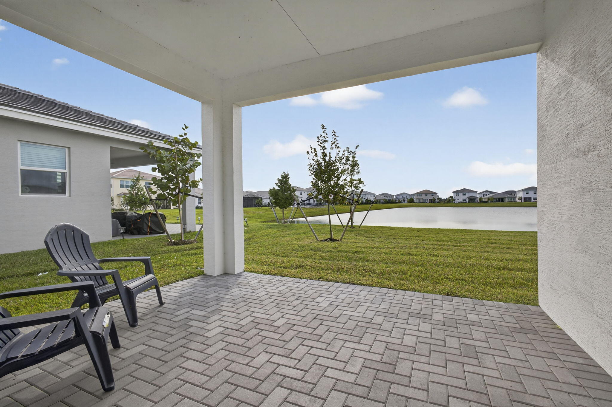 14052 Spruce Pne Drive Loxahatchee, FL 33470 - Photo 38 of 59 a view of a chair and table in backyard of the house