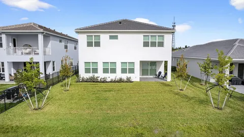 an aerial view of residential houses with outdoor space and ocean view