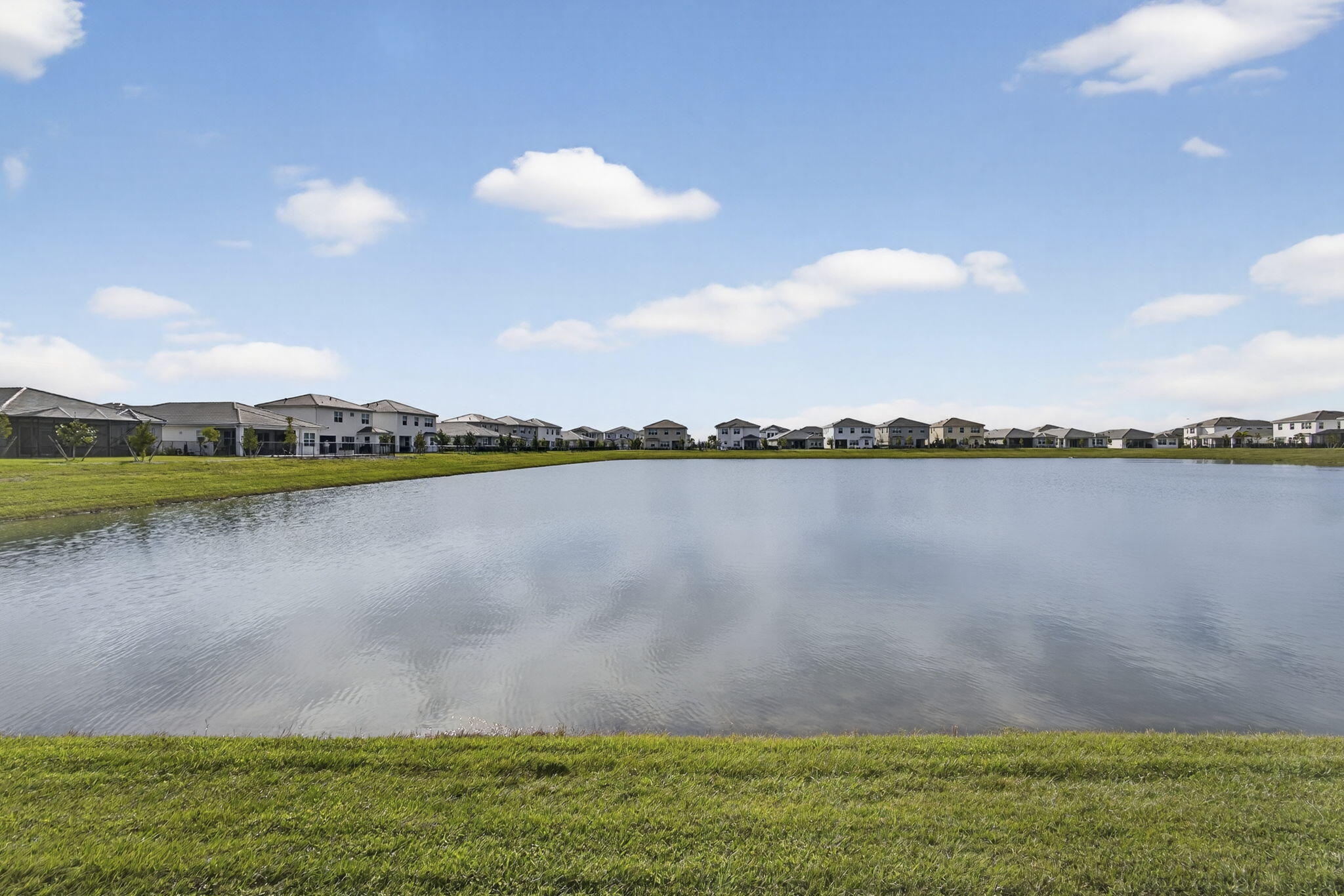 14052 Spruce Pne Drive Loxahatchee, FL 33470 - Photo 42 of 59 a view of a lake with houses in the back