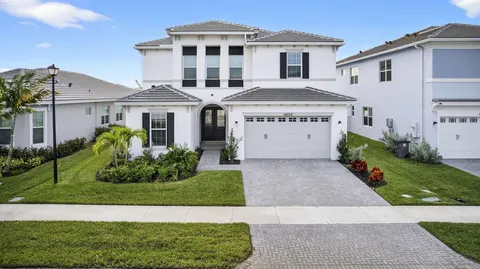 an aerial view of residential houses with outdoor space and lake view