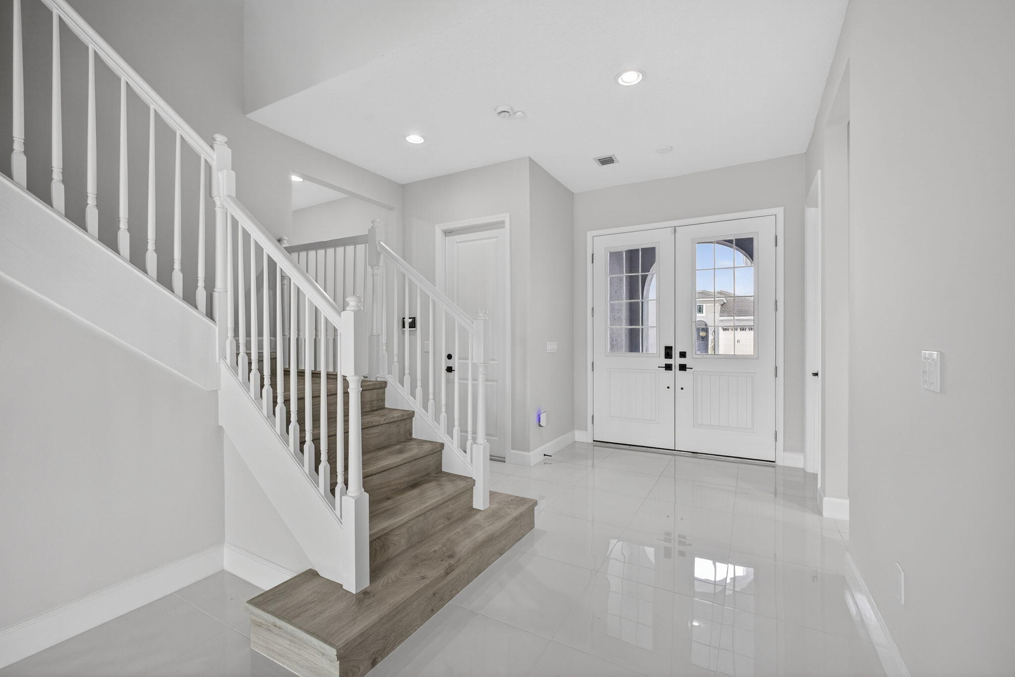 14052 Spruce Pne Drive Loxahatchee, FL 33470 - Photo 5 of 59 a view of a hallway with white walls and stairs