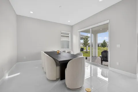 a dining room with furniture and wooden floor