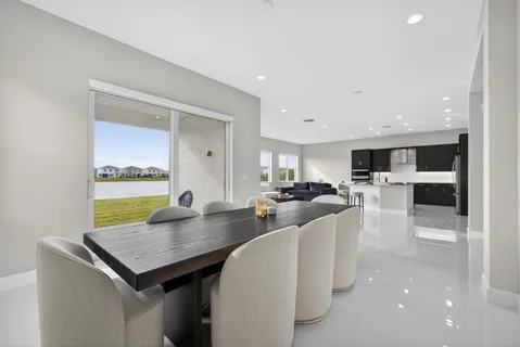 a large kitchen with a table and chairs