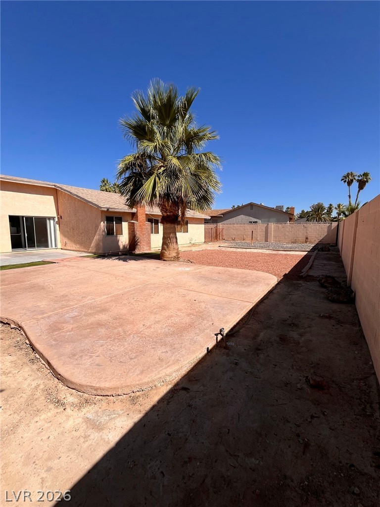 5348 Ravendale Circle Las Vegas, NV 89120 - Photo 14 of 14 A spacious backyard with mature palm tree and a concrete patio awaits your personal touch.