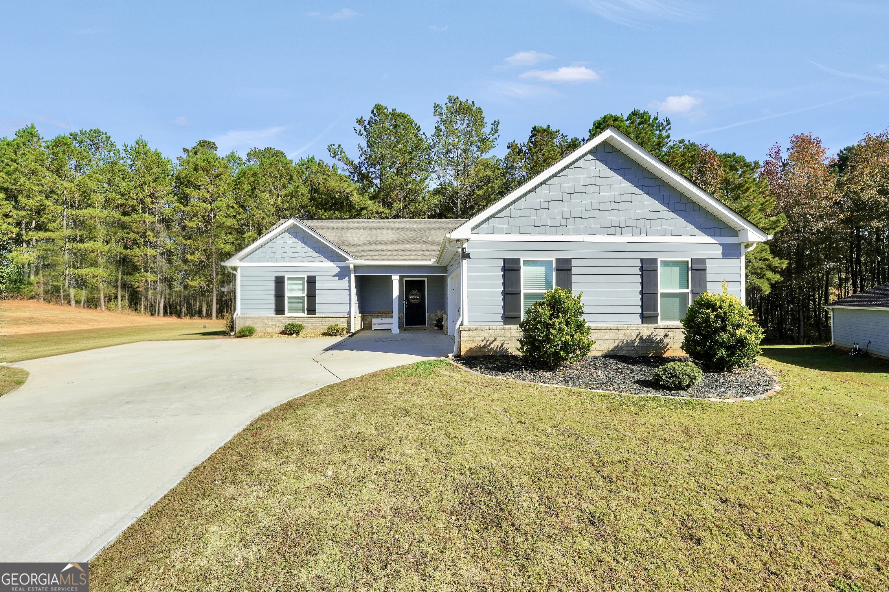 129 Magnolia Trail Milner, GA 30257 - Photo 1 of 29 a front view of house with yard and green space