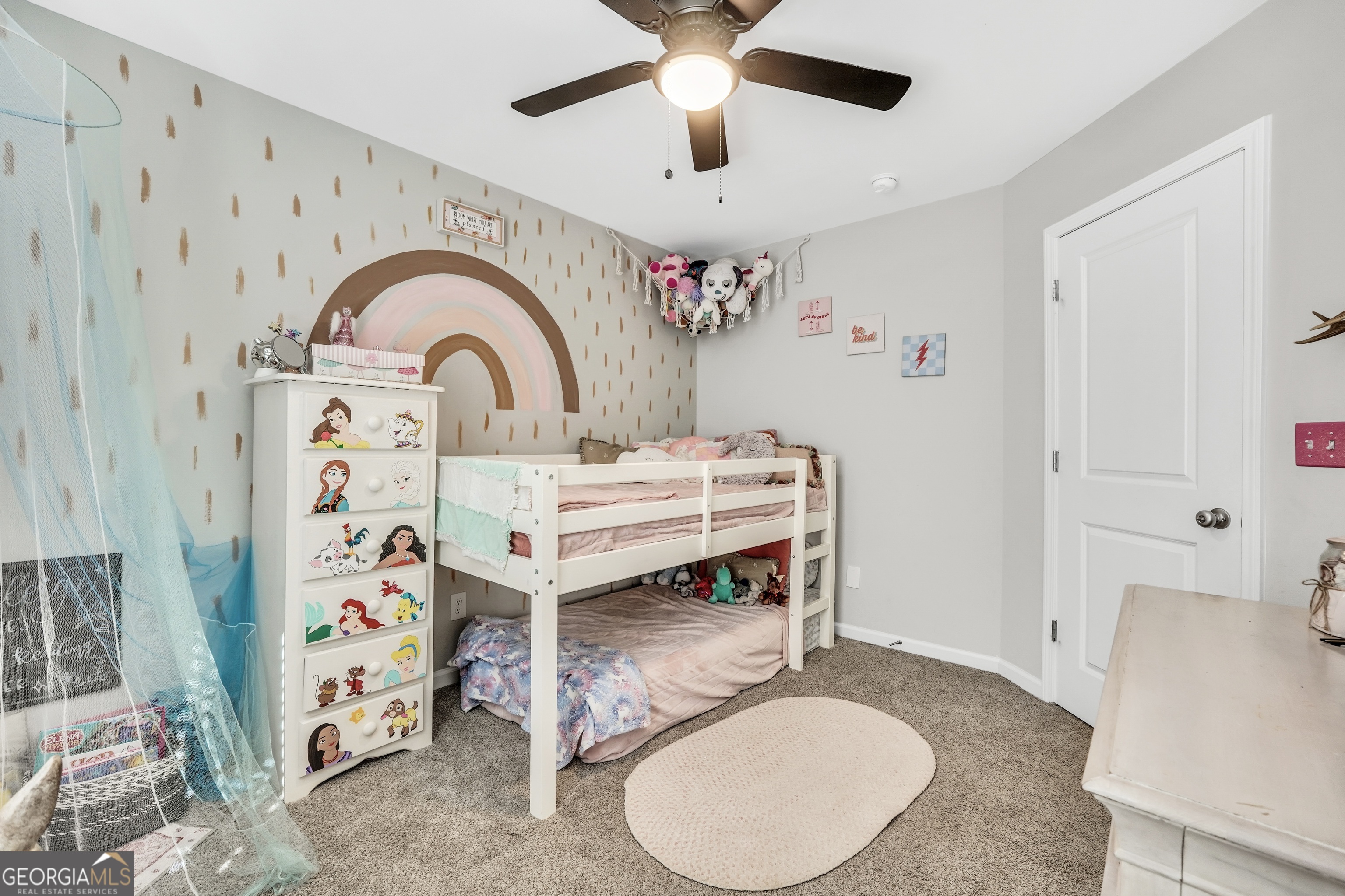 129 Magnolia Trail Milner, GA 30257 - Photo 20 of 29 a bedroom with a bed and a chandelier