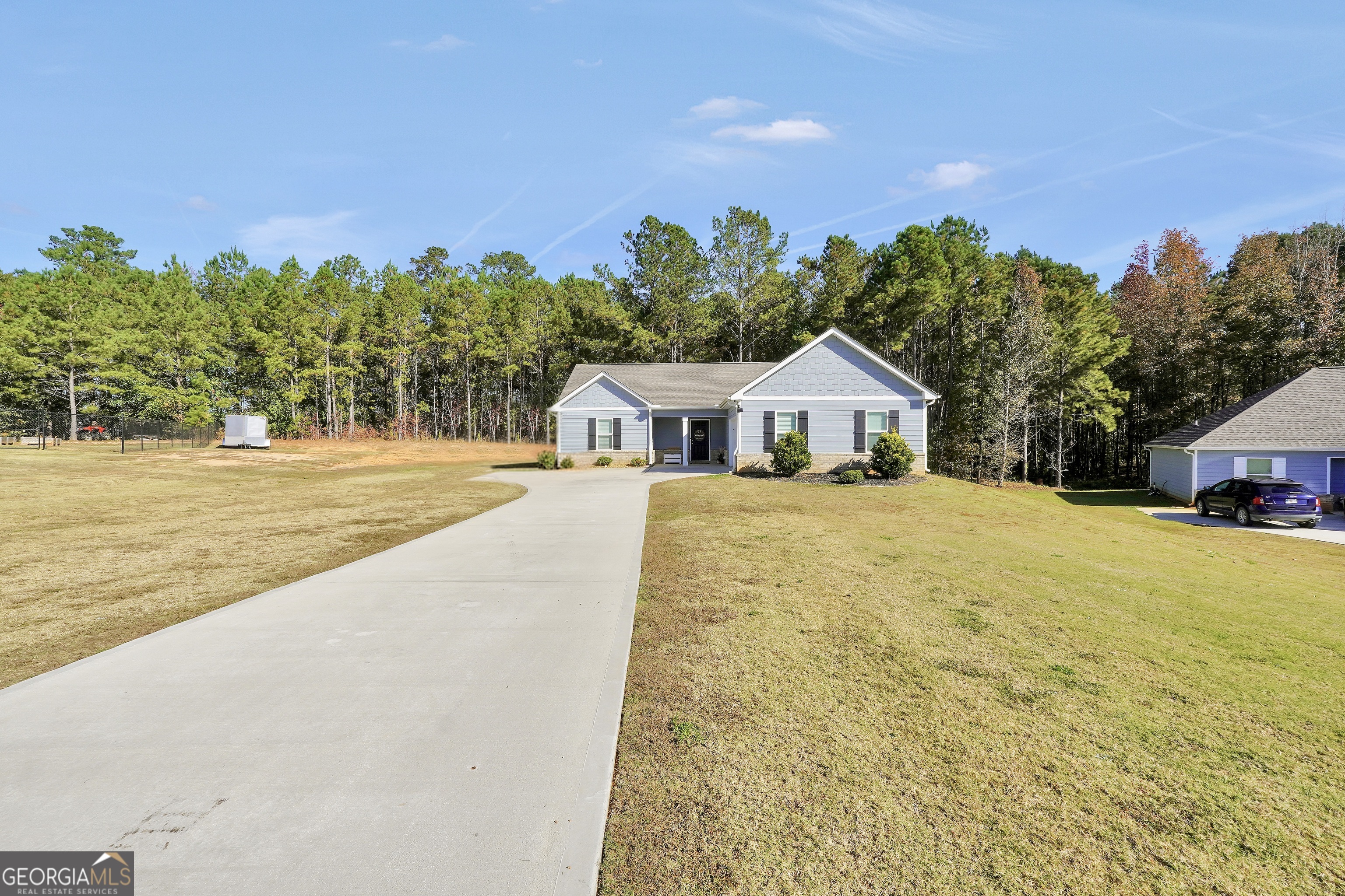 129 Magnolia Trail Milner, GA 30257 - Photo 2 of 29 a house with trees in the background