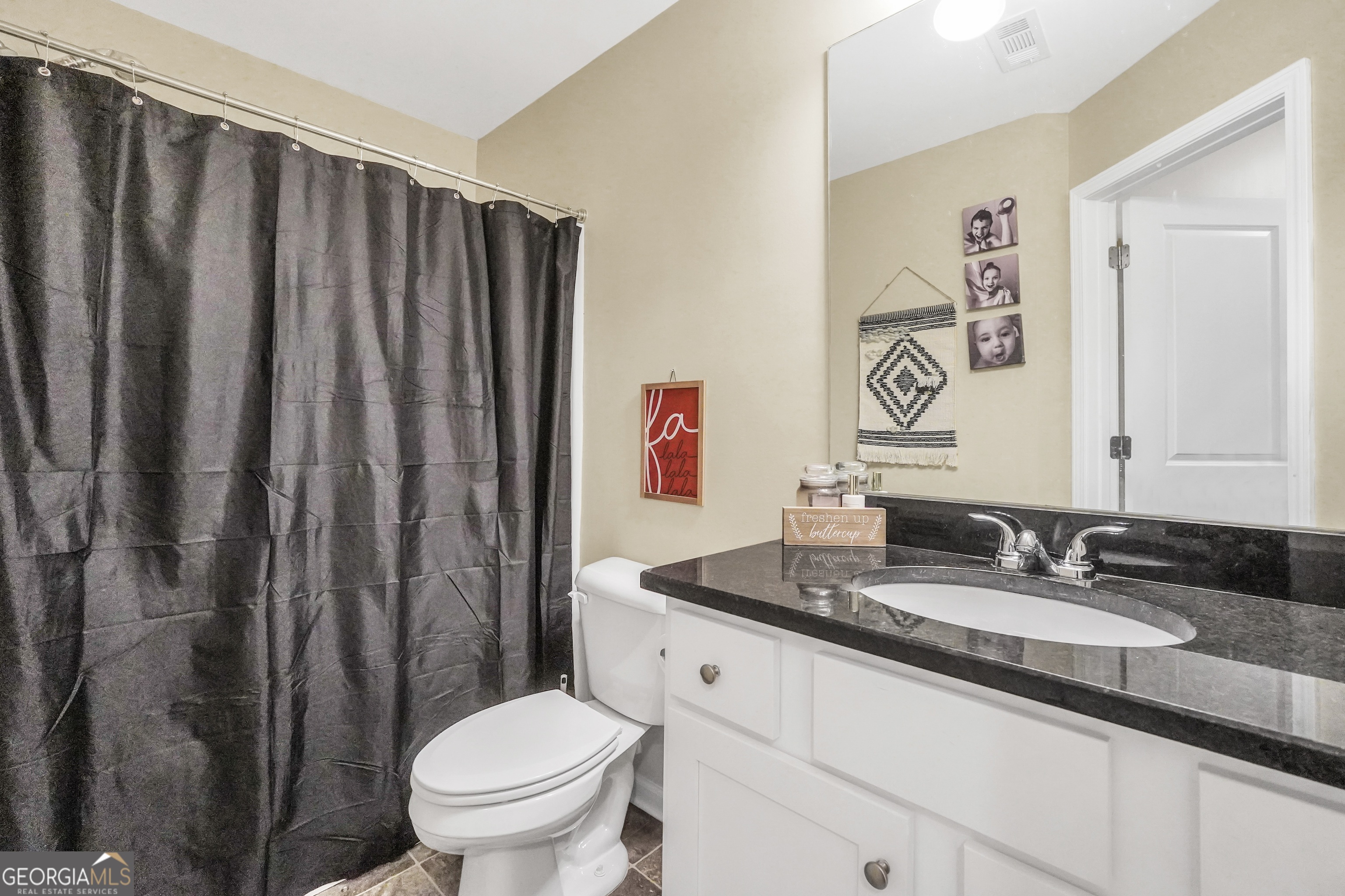 129 Magnolia Trail Milner, GA 30257 - Photo 22 of 29 a bathroom with a granite countertop sink and a mirror