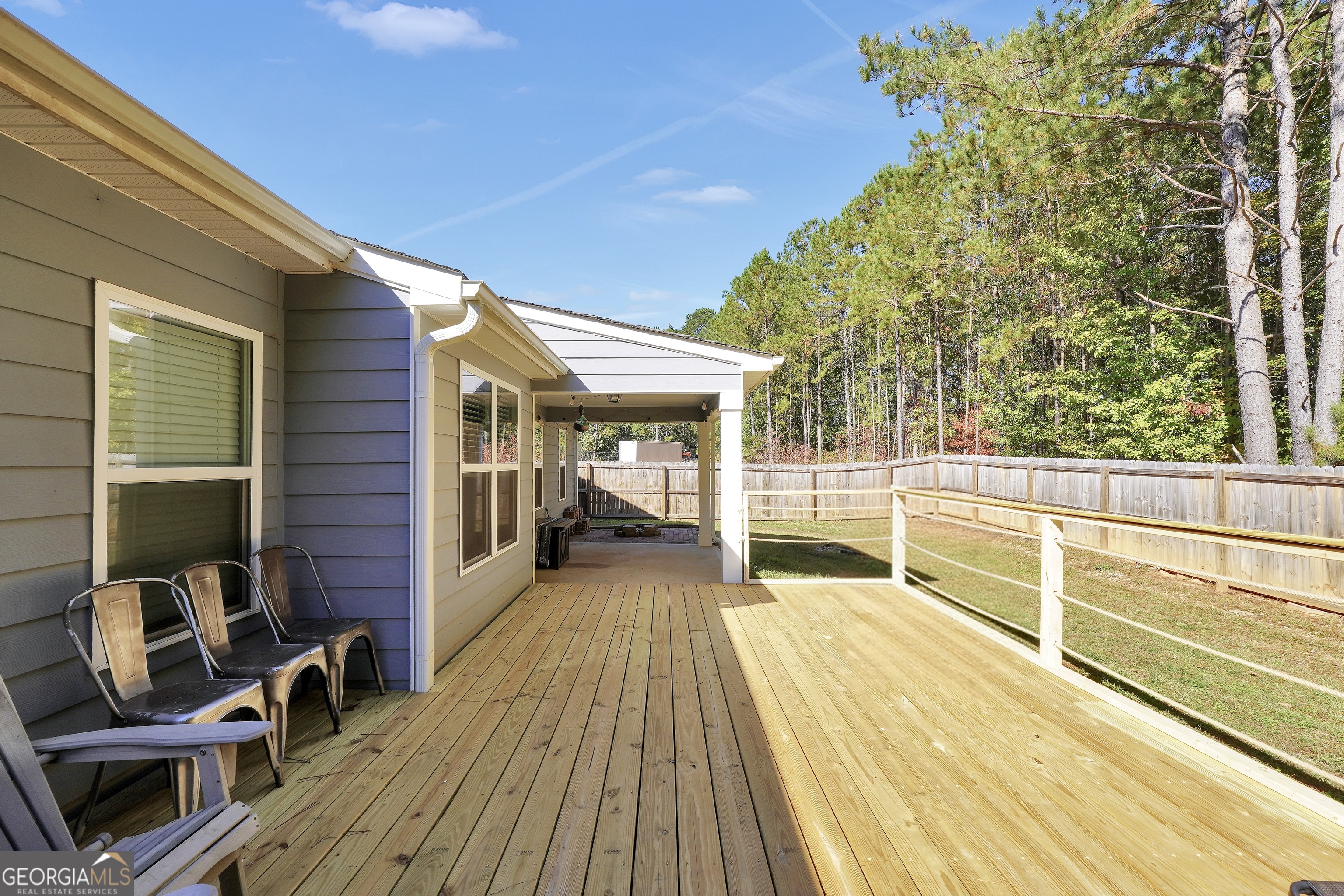 129 Magnolia Trail Milner, GA 30257 - Photo 26 of 29 a view of a balcony with chairs and wooden floor