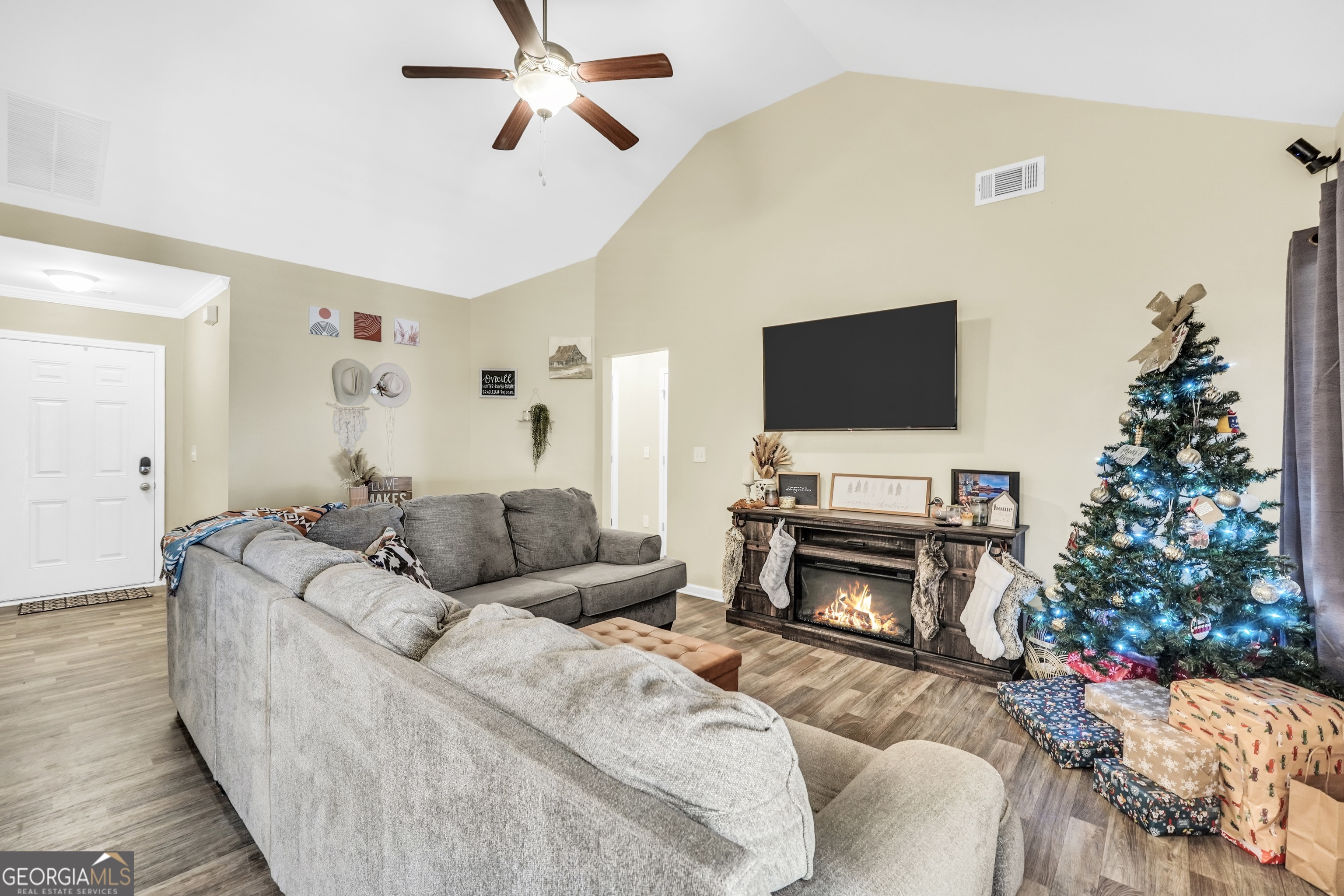 129 Magnolia Trail Milner, GA 30257 - Photo 8 of 29 a living room with furniture a flat screen tv and a fireplace