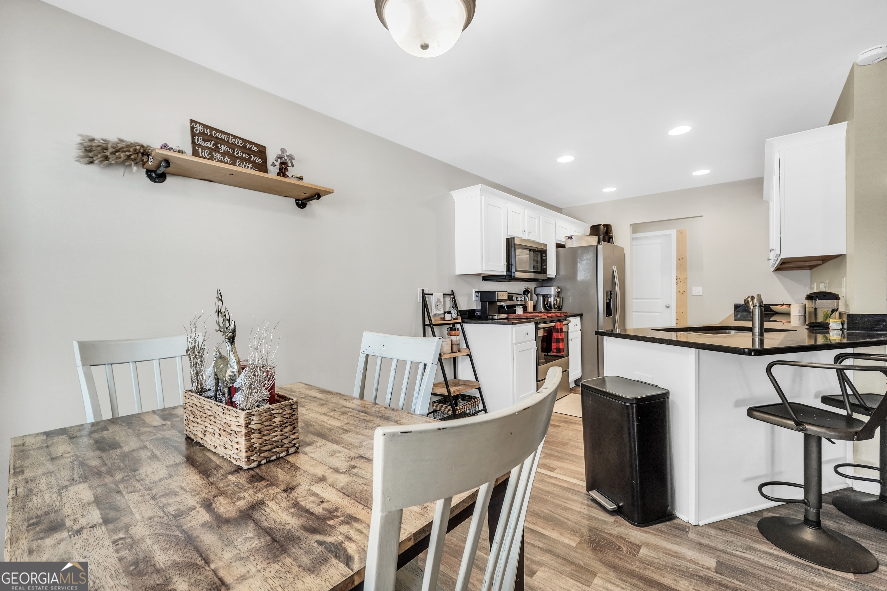 129 Magnolia Trail Milner, GA 30257 - Photo 10 of 29 a kitchen with kitchen island a appliances dining table chairs and cabinets