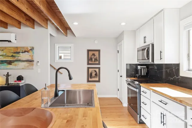a kitchen with stainless steel appliances granite countertop a sink and cabinets