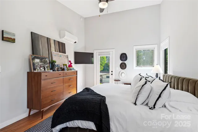 a bedroom with a bed and flat screen tv