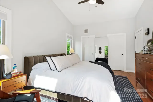 a bedroom with a bed and wooden floor