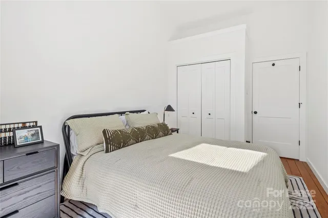 a bedroom with a bed and a night stand