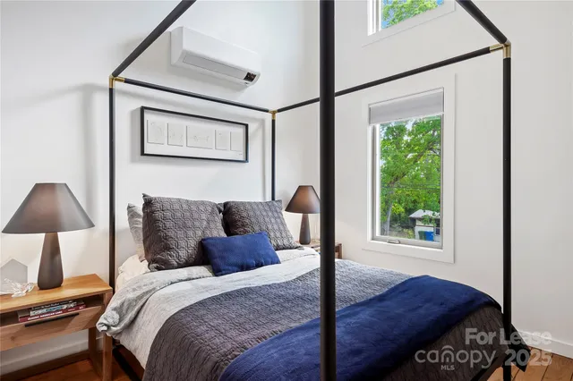 a bed sitting in a bedroom next to a window