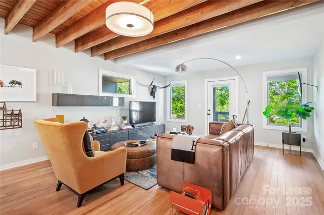 a living room with furniture fireplace and wooden floor