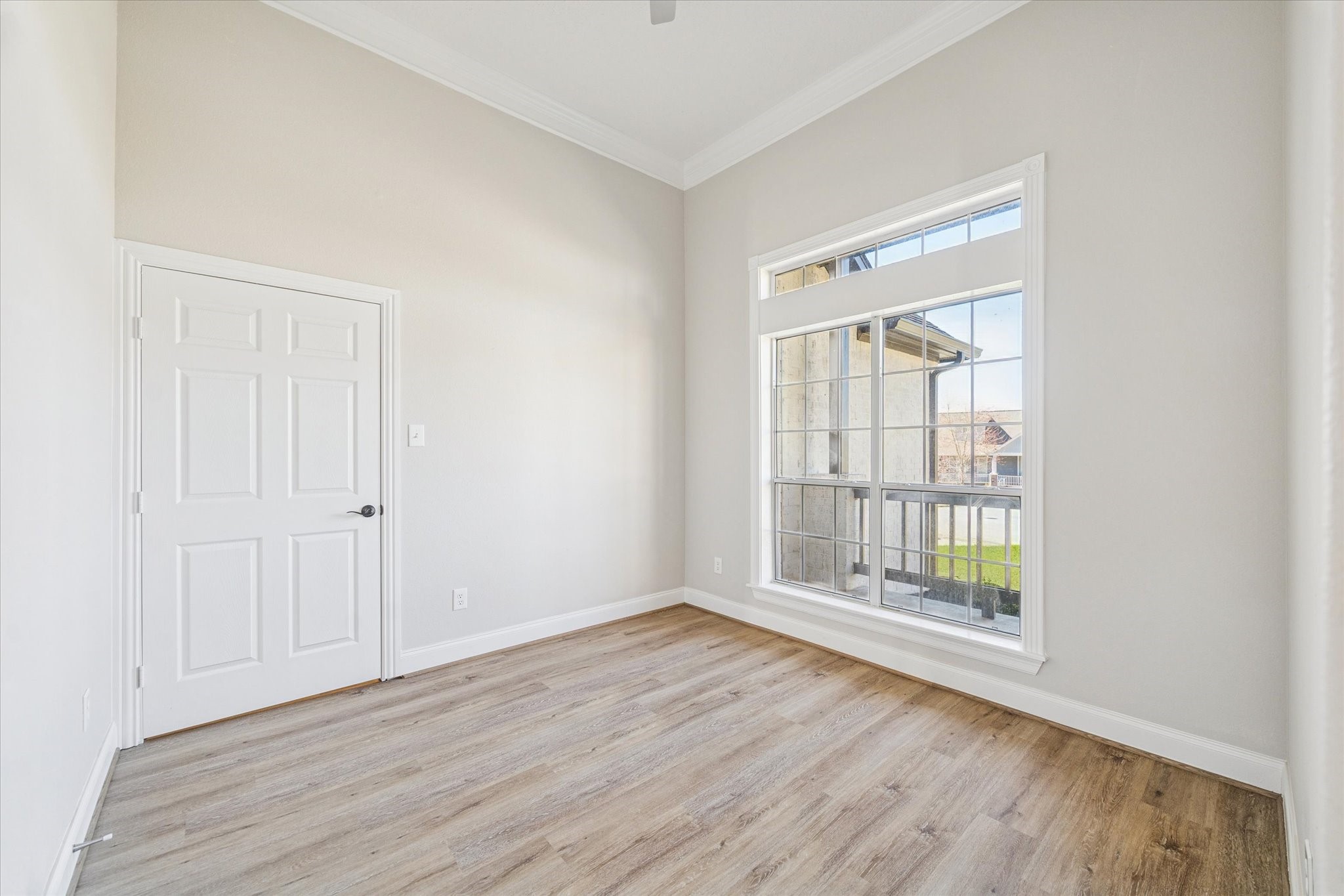5437 Edgewater Court Willis, TX 77318 - Photo 20 of 29 an empty room with wooden floor and windows