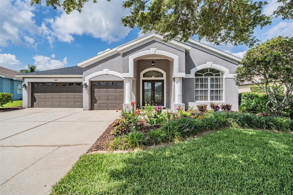 a front view of a house with garden