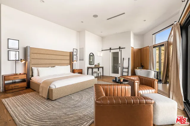 a living room with furniture and a floor to ceiling window