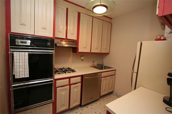 85 East India Row, Unit 25D Boston, MA 02110 - Photo 3 of 8 a kitchen with stainless steel appliances a stove a microwave and a sink