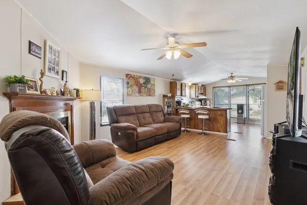 a living room with furniture fireplace and flat screen tv