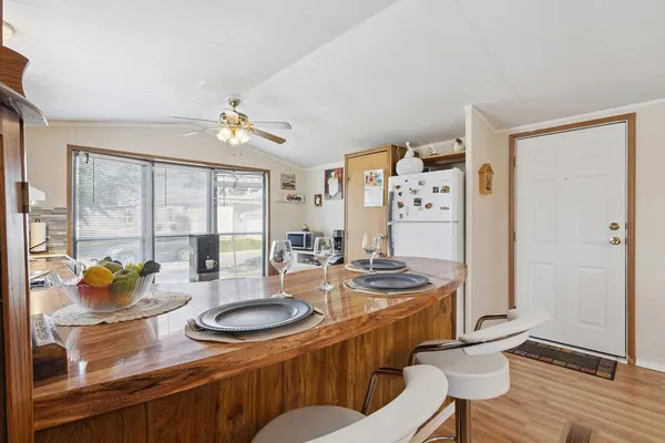 a dining room with furniture a chandelier and wooden floor
