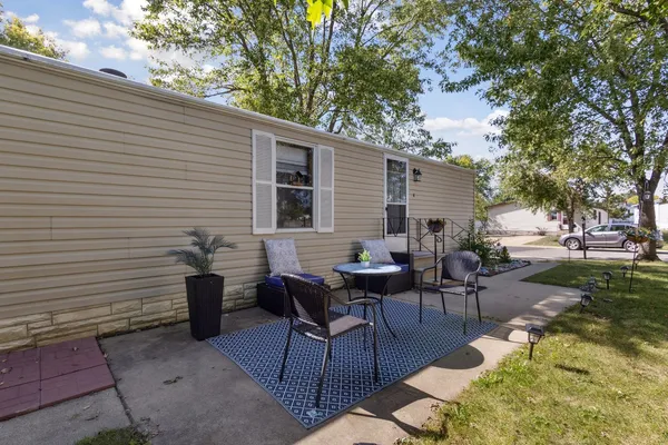 a backyard of a house with outdoor seating