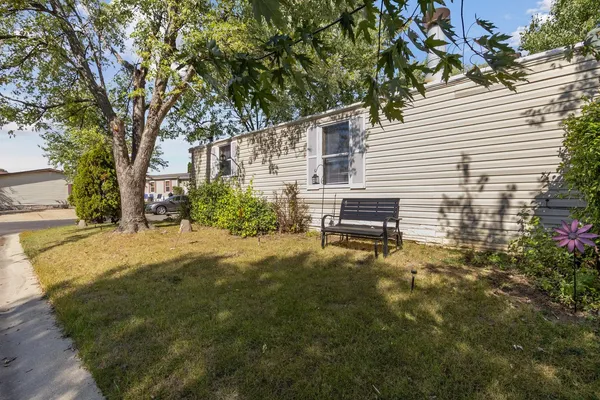 a backyard of a house with table and chairs